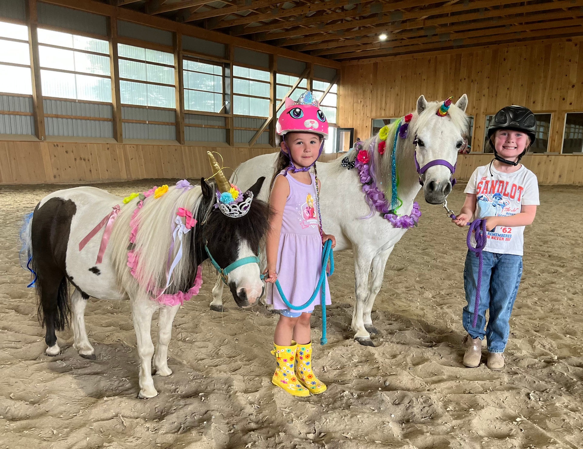 Children leading decorated miniature horses in our indoor arena